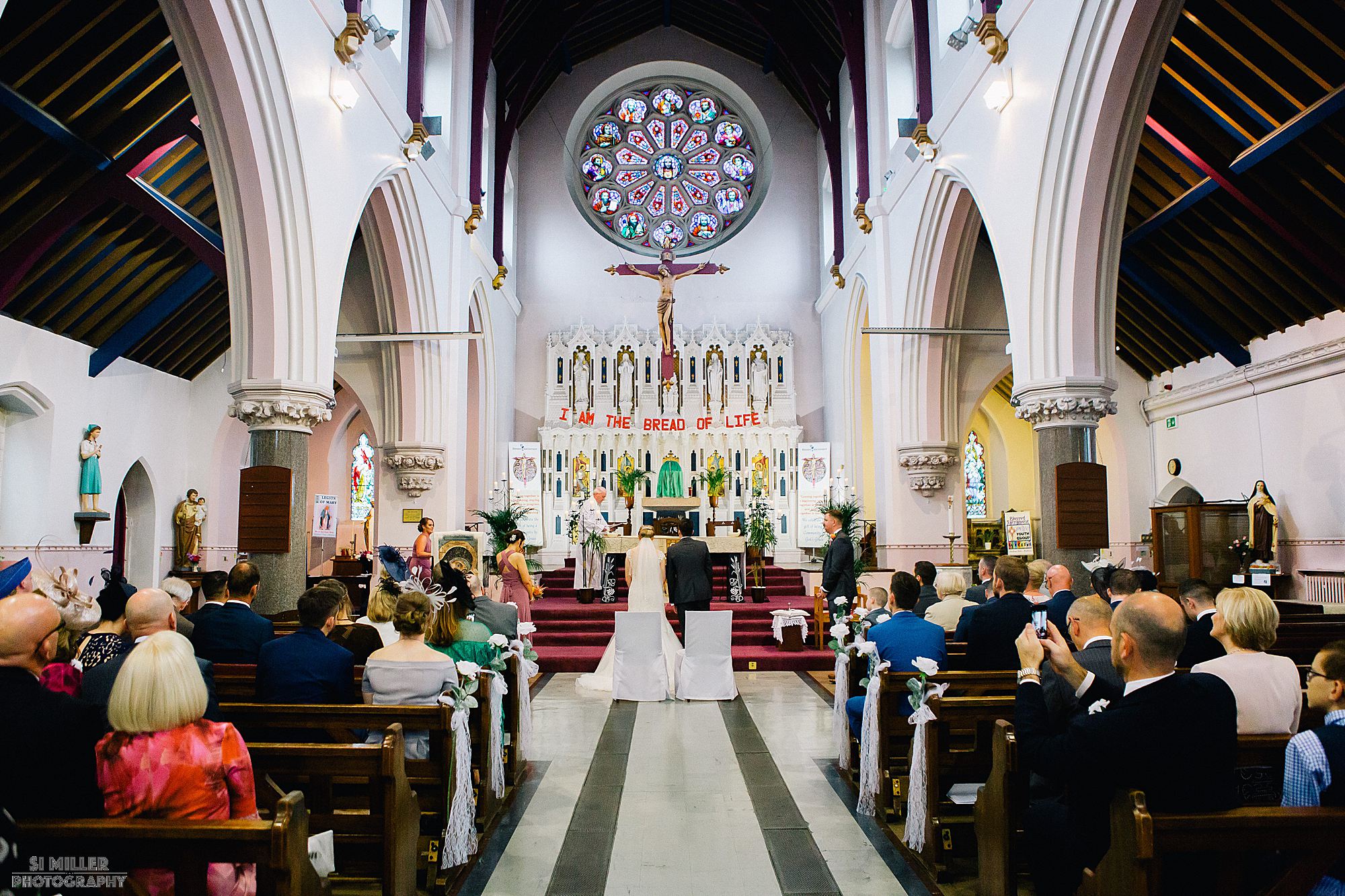 bride and groom at alter during wedding ceremony at Blessed Sacred Church Liverpool