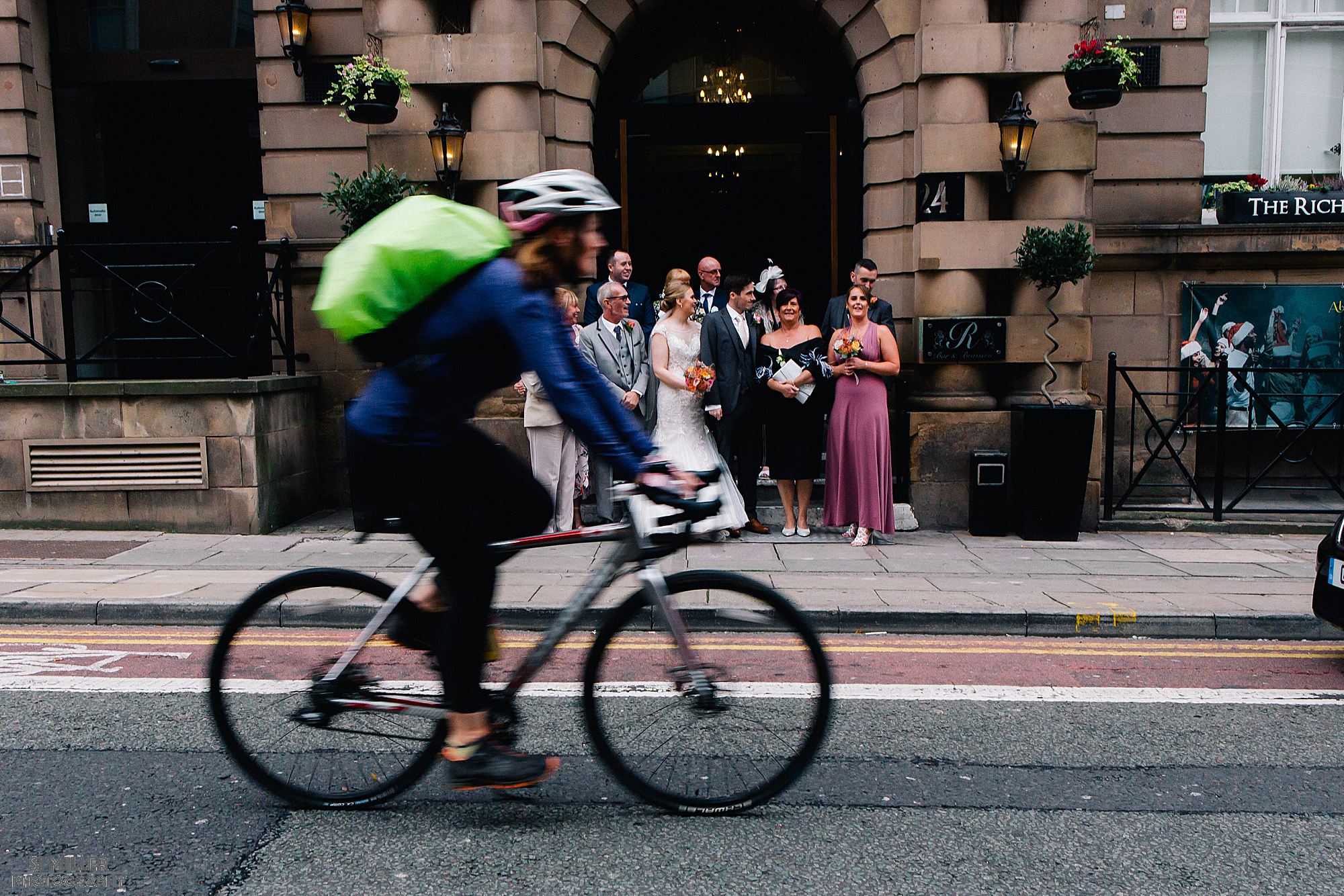 cyclist passing bridal party 