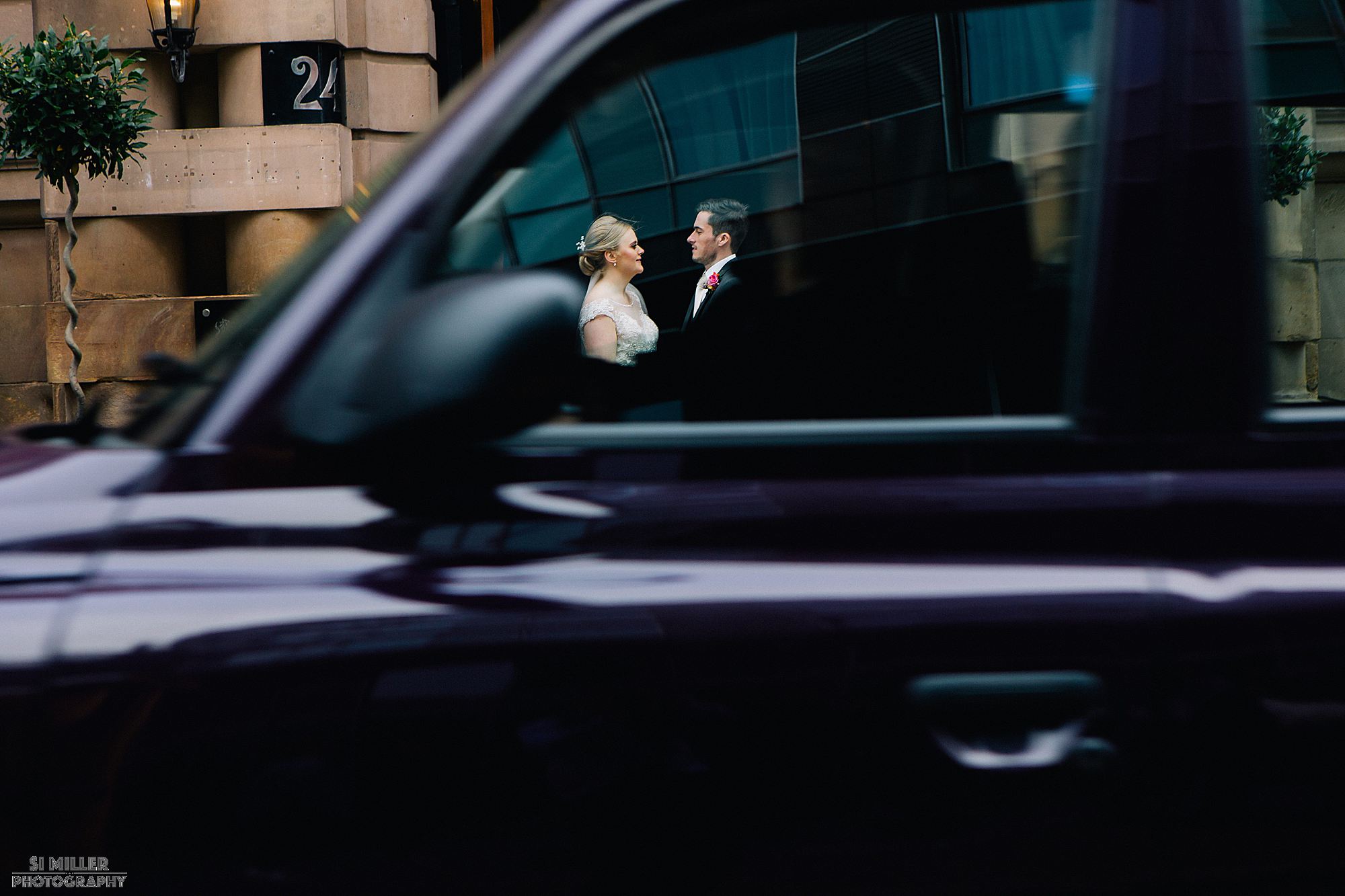 bride and groom through a moving taxi at Richmond Hotel liverpool