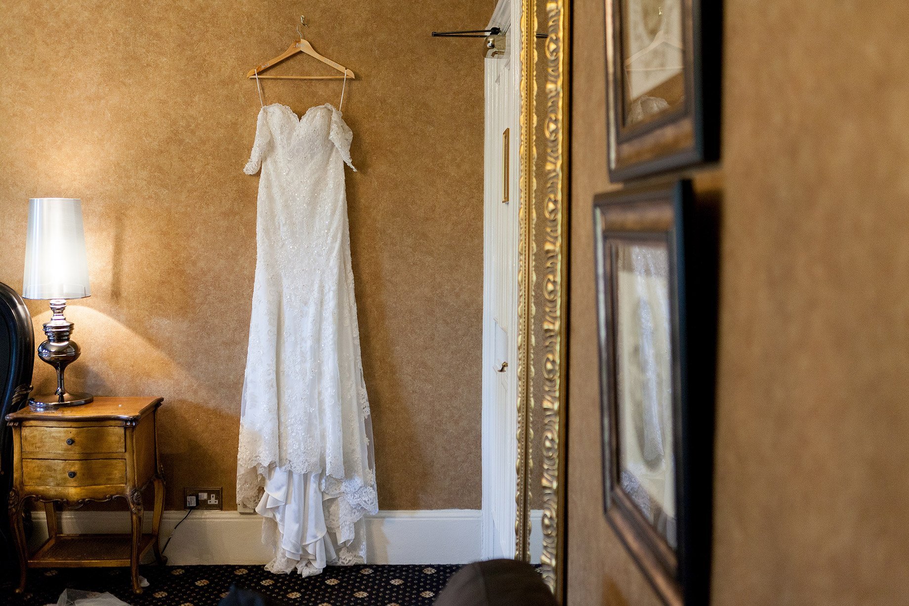 Wedding dress hanging on wall at Liverpool Sefton Park Sure Hotel