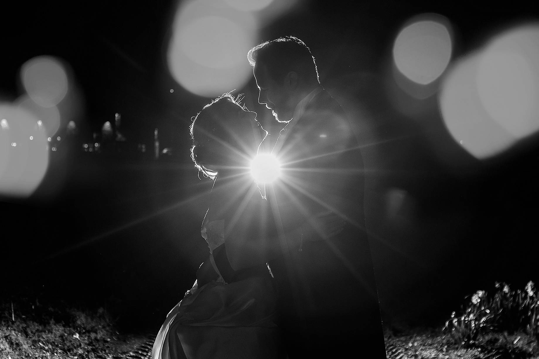 Bride and groom cuddling at night with a flash 