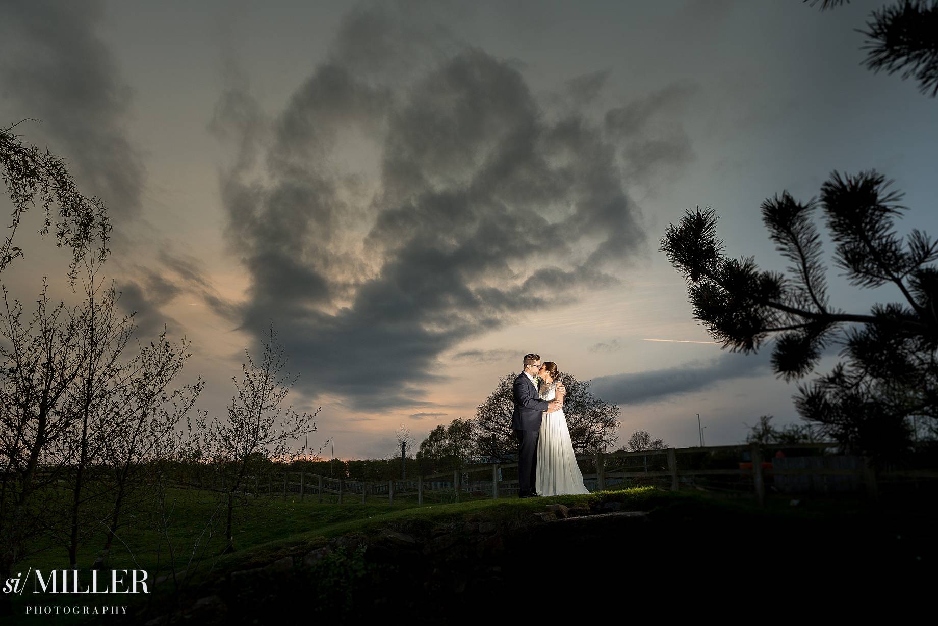 bride and groom kissing light by flash at Charnock Farm