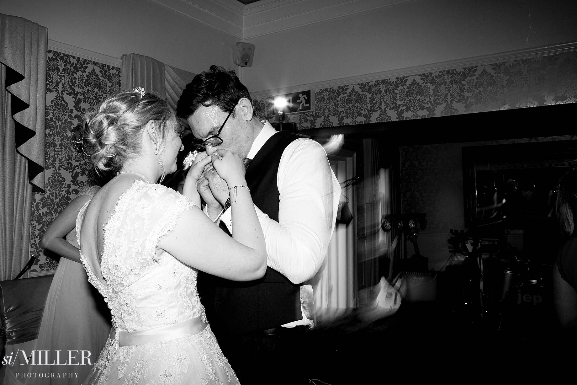 groom kissing brides hands on the dance floor at Bartle Hall Preston.